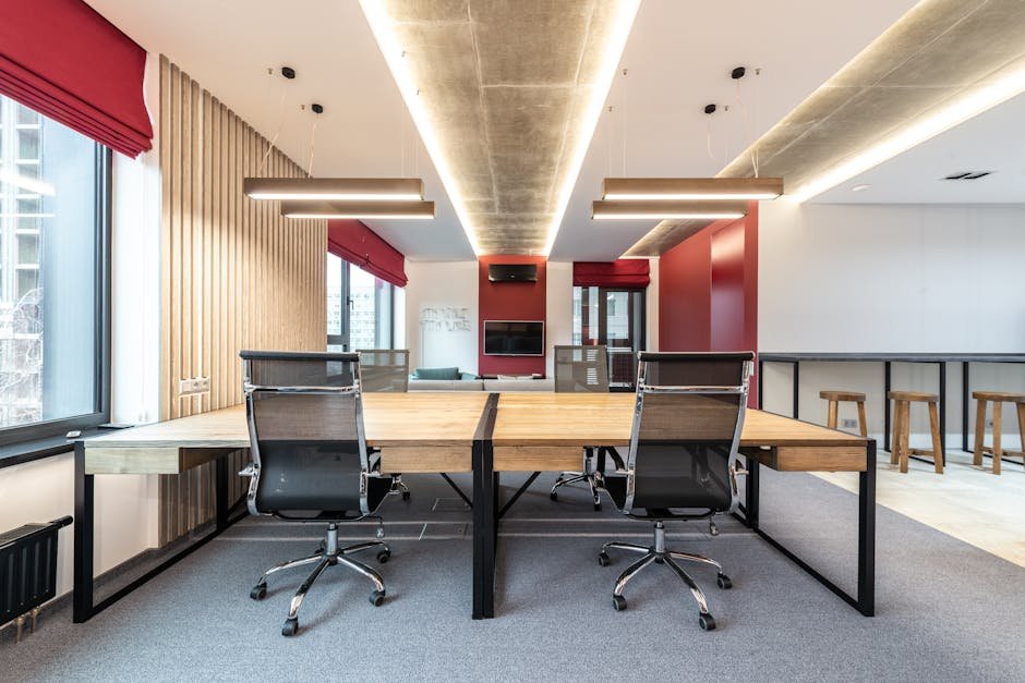 Spacious contemporary office with wooden desks and ergonomic chairs.