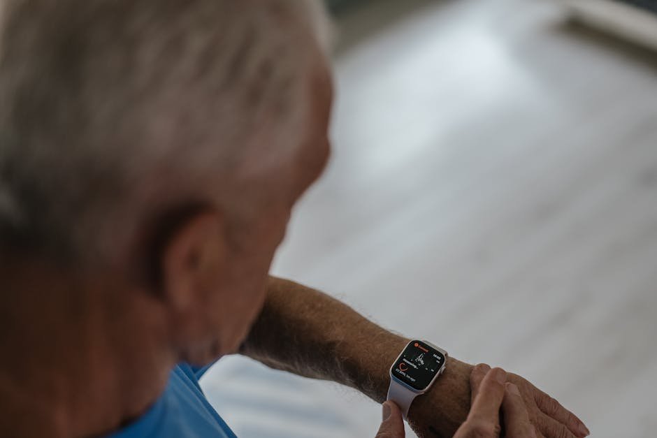 A senior man interacts with a smartwatch indoors, focusing on technology and lifestyle.